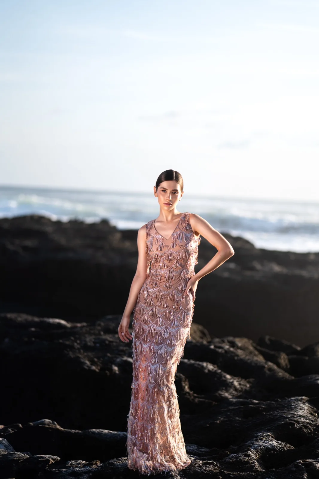 Rose-gold beaded fringe look photographed on the beach
